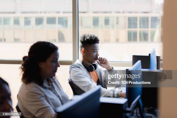 classmates working on the computer - high school senior stock pictures, royalty-free photos & images