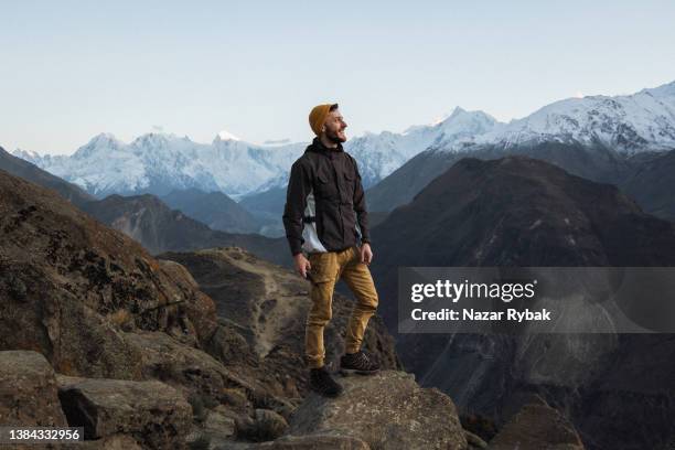 a young man enjoy the sunset in himalayas mountain - himalayas climbers stock pictures, royalty-free photos & images