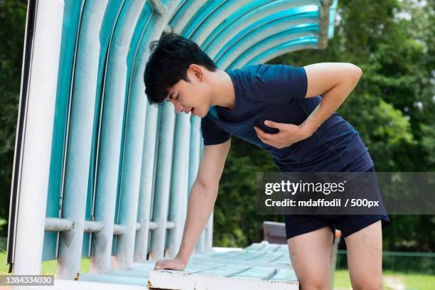 young athletic man suffering heart attack after workout exercise - chest pain stock pictures, royalty-free photos & images