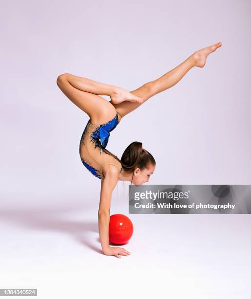 rhythmics gymnast girl 11 years old exercising ball routine - 12 13 years girls stock pictures, royalty-free photos & images