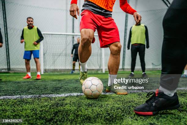 soccer player dribbling ball on field - shooting at goal stock pictures, royalty-free photos & images