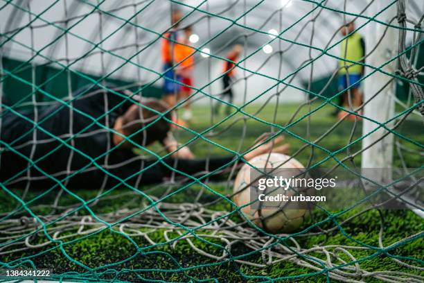 soccer goalkeeper failed saving goal - soccer goalkeeper stock pictures, royalty-free photos & images