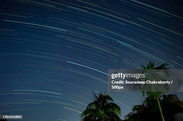 beauty of the night sky,low angle view of star trails against sky at night,guwahati,assam,india - guwahati stock pictures, royalty-free photos & images