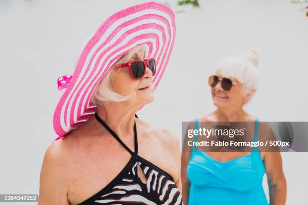 happy seniors in the swimming pool - old woman in swimsuit stock-fotos und bilder