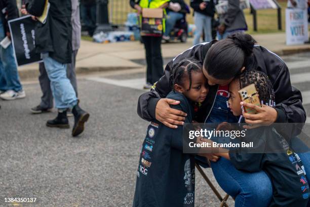 Malita Tyre sits with her grandchildren Curtis and T'kyrra at the Alabama State Capitol on March 11, 2022 in Montgomery, Alabama. Community...