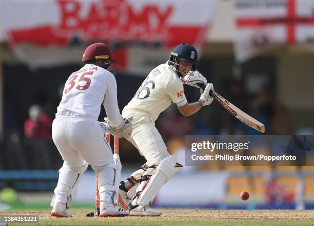 Joe Root of England bats during the fourth day of the first Test against West Indies at Sir Vivian Richards Stadium on March 11, 2022 in Antigua,...