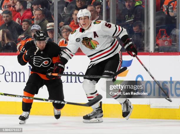 Cam Atkinson of the Philadelphia Flyers skates against Connor Murphy of the Chicago Blackhawks at the Wells Fargo Center on March 5, 2022 in...