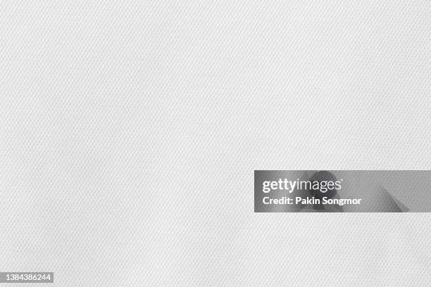 fabric for sports clothing in a white color, the texture of a football shirt jersey, and a textile background - polyester fotografías e imágenes de stock