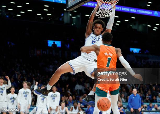 Paolo Banchero of the Duke Blue Devils dunks as Anthony Walker of the Miami Hurricanes defends during the second half in the 2022 Men's ACC...