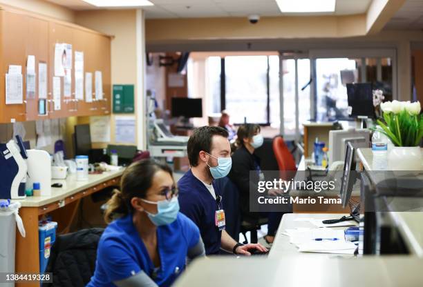 Jesse Cabe and other registered nurses work in the ICU at Providence St. Mary Medical Center on March 11, 2022 in Apple Valley, California. The...