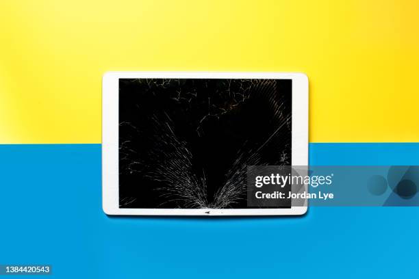 broken tablet on color background - smashed ipad screen stock pictures, royalty-free photos & images