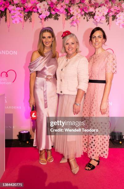 Kate Waterhouse and Tracy Bevan and Diana Johnson attend Chandon Ladies Day at Rosehill Gardens on March 12, 2022 in Sydney, Australia.