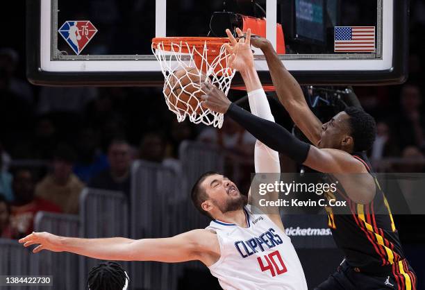 Onyeka Okongwu of the Atlanta Hawks draws a foul as he dunks over Ivica Zubac of the Los Angeles Clippers during the second half at State Farm Arena...