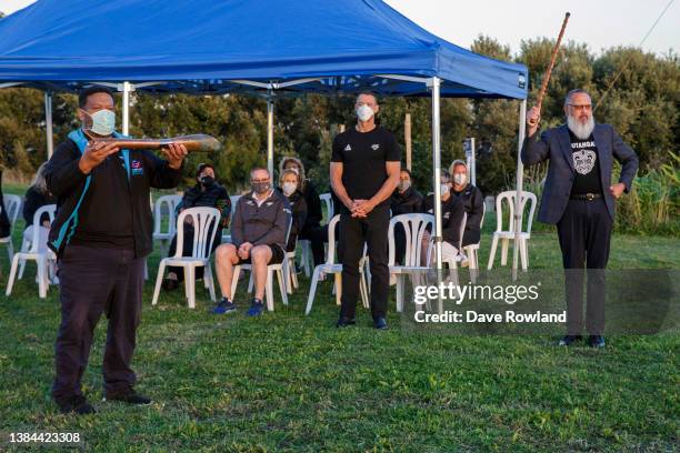 Local school teacher Tei Nohotima receives the Queen's Baton from Chef de Mission Nigel Avery and Derek Lardelli, Mätua for the New Zealand Team...