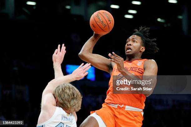 Justyn Mutts of the Virginia Tech Hokies goes to the basket as Brady Manek of the North Carolina Tar Heels defends during the first half in the 2022...