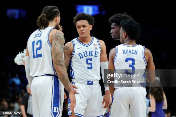 Paolo Banchero of the Duke Blue Devils talks with his teammates during the first half against the Miami Hurricanes in the 2022 Men's ACC Basketball...