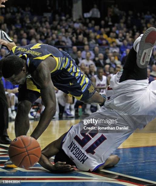 Moses Morgan of the DePaul Blue Demons lands on his head after flipping over Darius Johnson-Odom of the Marquette Golden Eagles at Allstate Arena on...