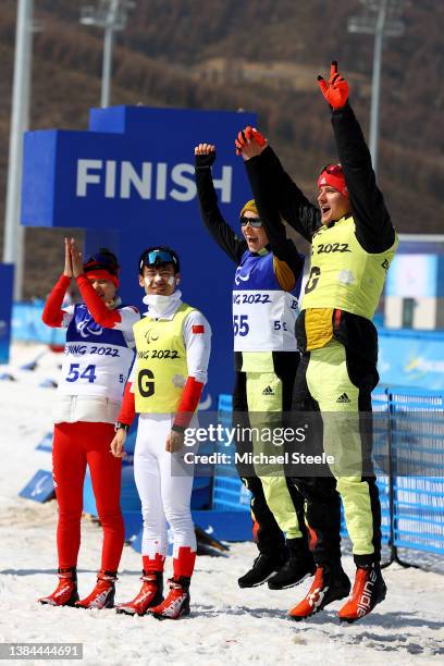 Gold medalist Linn Kazmaier of Team Germany and guide Florian Baumann and Silver medalist Yue Wang of Team China and guide Yalin Li celebrate during...