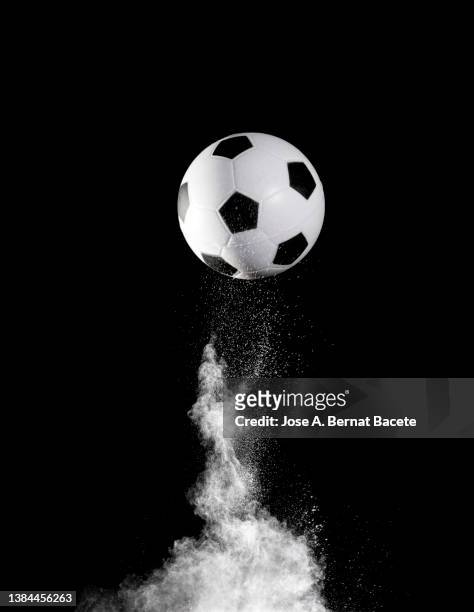 impact and rebound of a soccer ball on a surface of earth and gunpowder on a black background - 足球賽事 個照片及圖片檔