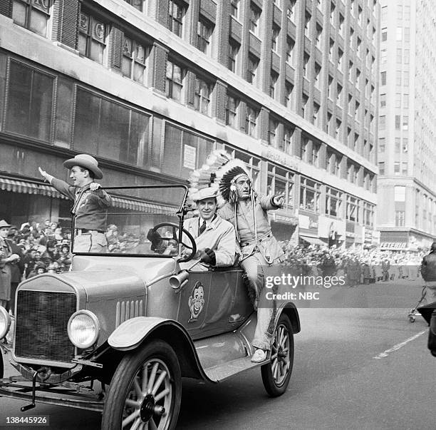 Pictured: A car drives by with Howdy Doody characters Bob Smith as Buffalo Bob Smith and Bill LeCornec as Chief Thunderthud during the 1954 Macy's...