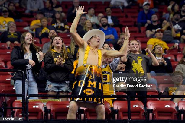 Wyoming Cowboys fan Ken "Cowboy Ken Barrel Man" Koretos of Wyoming cheers during a semifinal game of the Mountain West Conference basketball...