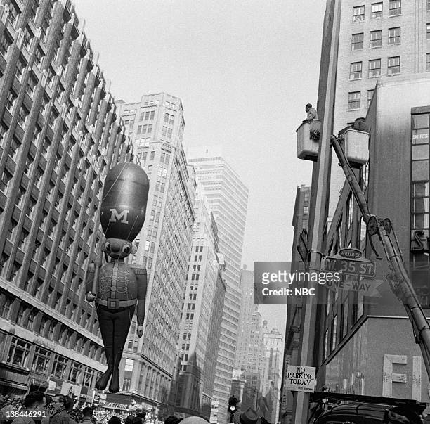 Pictured: Large balloons pass overhead during the 1954 Macy's Thanksgiving Day Parade
