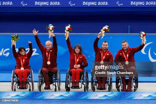 Bronze medalists of Team Canada celebrate during the Wheelchair Curling medal ceremony on day eight of the Beijing 2022 Winter Paralympics at...