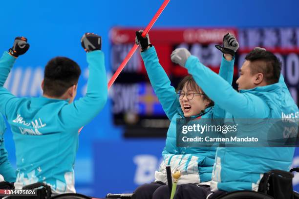 Zhuo Yan of Team China celebrates with teammates Mingliang Zhang and Haitao Wang after winning the Wheelchair Curling Gold Medal Game against Sweden...