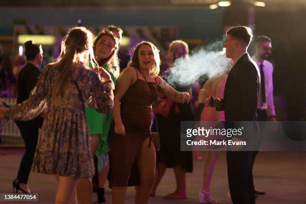 Man is seen vaping as racegoers leave the track after Sydney Racing Chandon Ladies Day at Rosehill Gardens on March 12, 2022 in Sydney, Australia.