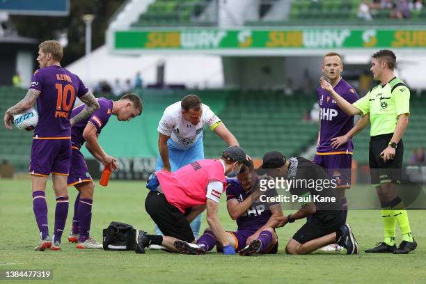 Glory medical staff attend to Brandon O'Neill of the Glory following a tackle by Alex Wilkinson of Sydney during the A-League Mens match between...