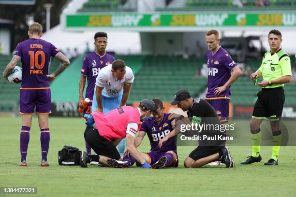 Glory medical staff attend to Brandon O'Neill of the Glory following a tackle by Alex Wilkinson of Sydney during the A-League Mens match between...