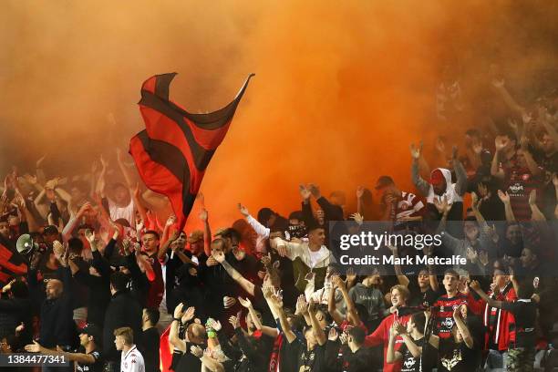 Wanderers fans let off a flare during the A-League Mens match between Macarthur FC and Western Sydney Wanderers at Campbelltown Sports Stadium, on...