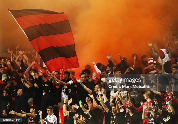 Wanderers fans let off a flare during the A-League Mens match between Macarthur FC and Western Sydney Wanderers at Campbelltown Sports Stadium, on...