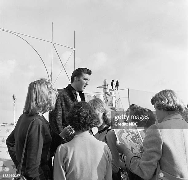 Episode 10 -- aired -- Pictured: Musician Elvis Presley and fans on the deck of the USS Hancock aircraft carrier.