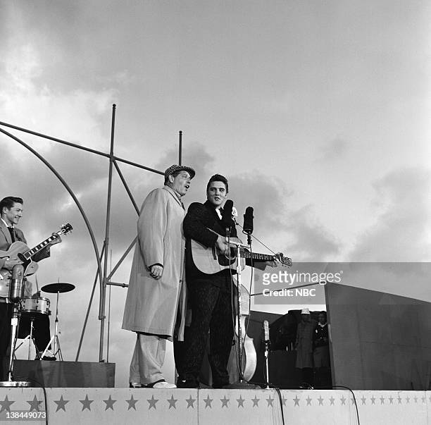 Episode 10 -- Pictured: Guitarist, Scotty Moore, host Milton Berle, Elvis Presley on the deck of the USS Hancock aircraft carrier