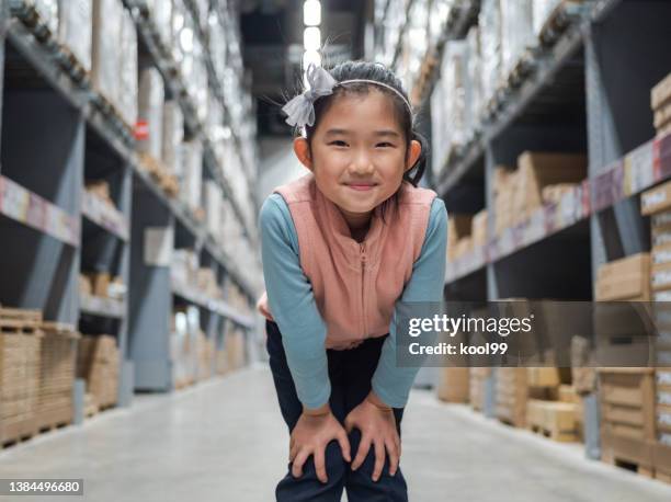 little girl in warehouse mall - hand on knee stock pictures, royalty-free photos & images
