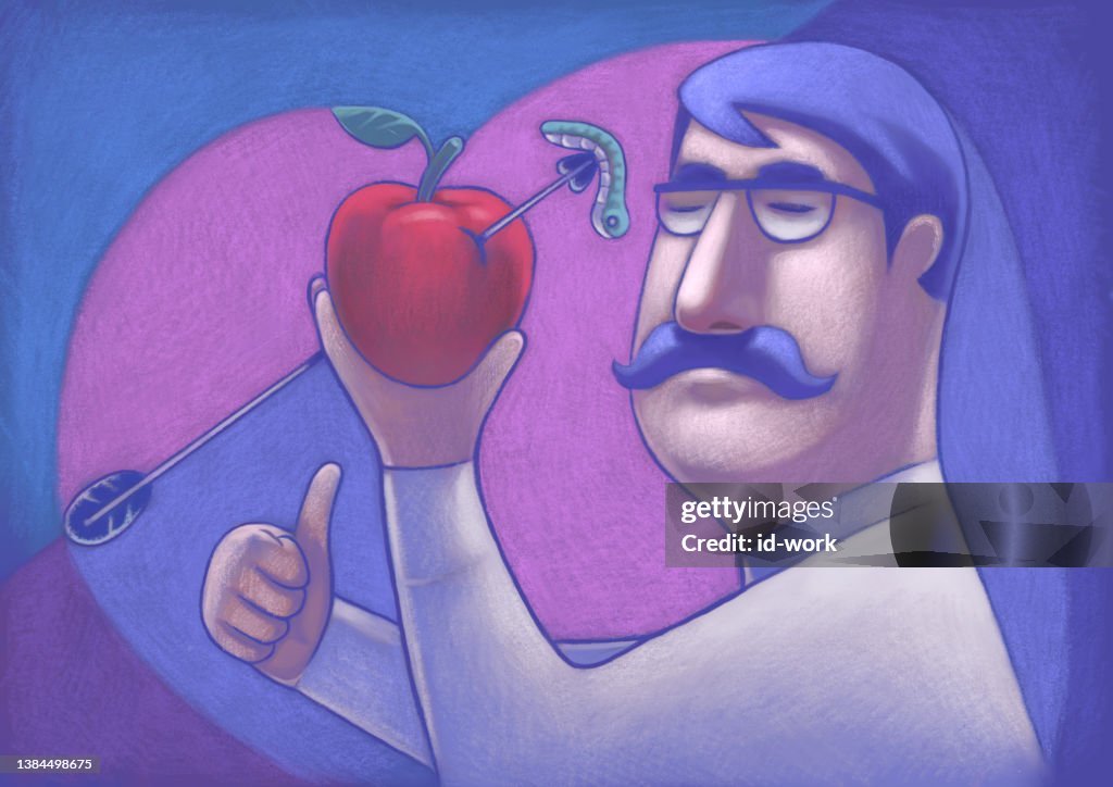 Man holding apple and gesturing thumbs up