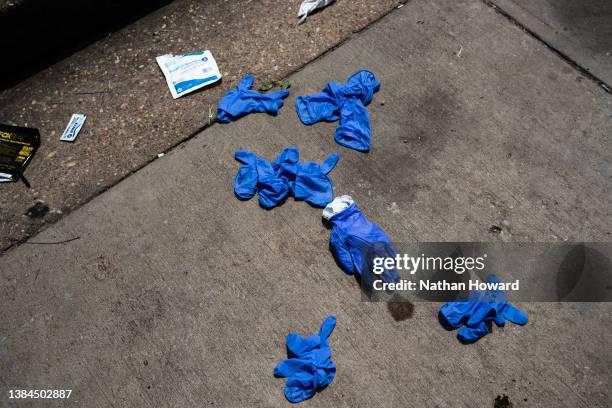 Gloves and other medical supplies are seen at the site of a mass shooting in the Brooklyn Homes neighborhood on July 2, 2023 in Baltimore, Maryland....