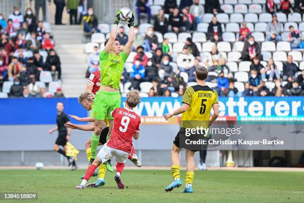 Silas Ostrzinski of Borussia Dortmund U19 saves the ball during the DFB Juniors Cup semi final match between SC Freiburg U19 and Borussia Dortmund...