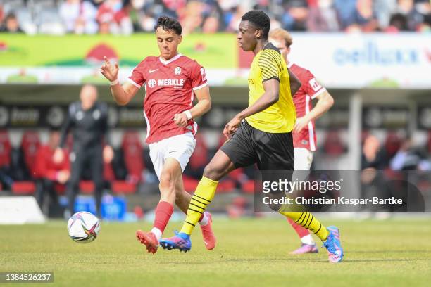 Abdoulaye Kamara of Borussia Dortmund U19 challenges Amney Moutassime of SC Freiburg U19 during the DFB Juniors Cup semi final match between SC...