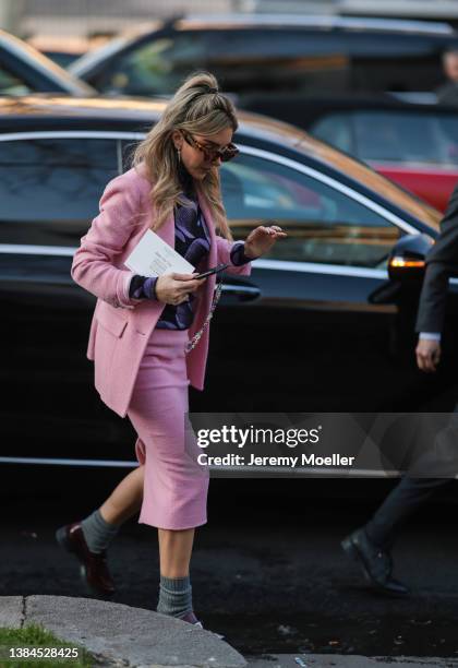 Helen David is seen wearing a pink blazer, a pink skirt, a purple and black shirt, Poppy Lissiman sunglasses, silver earrings and a Iphone on March...