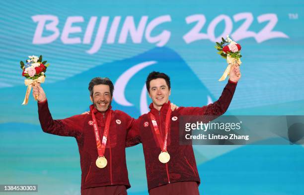 Gold medalist Brian McKeever of Canada and his guide Graham Nishikawa celebrate on the podium during the medal ceremony for the Men's Middle Distance...
