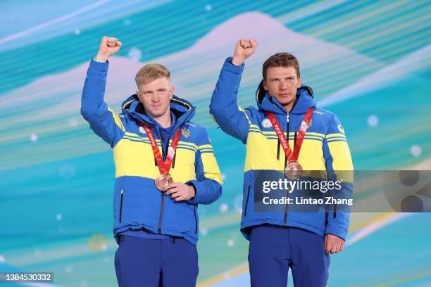 Bronze medalist Dmytro Suiarko of Team Ukraine and his guide Oleksandr Nikonovych celebrate on the podium during the medal ceremony for the Men's...