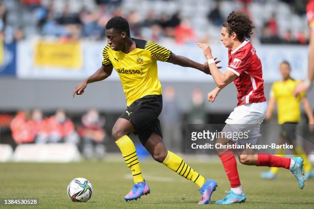 Abdoulaye Kamara of Borussia Dortmund U19 challenges Jamie Bynoe-Gittens of SC Freiburg U19 during the DFB Juniors Cup semi final match between SC...