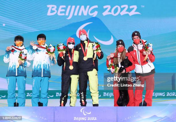 Silver medalist Yue Wang of Team China and their guide Yalin Li, Gold medalist Linn Kazmaier of Team Germany and their guide Florian Baumann and...