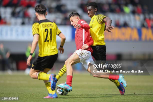 Tom Rothe of SC Freiburg U19 is tackled by Abdoulaye Kamara of Borussia Dortmund U19 during the DFB Juniors Cup semi final match between SC Freiburg...