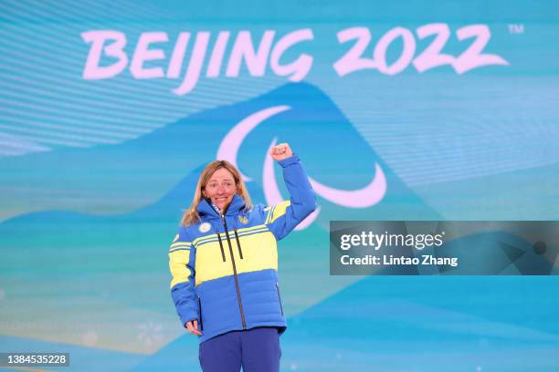 Gold medalist Oleksandra Kononova of Team Ukraine celebrates on the podium during the medal ceremony for the Women's Middle Distance Free Technique...