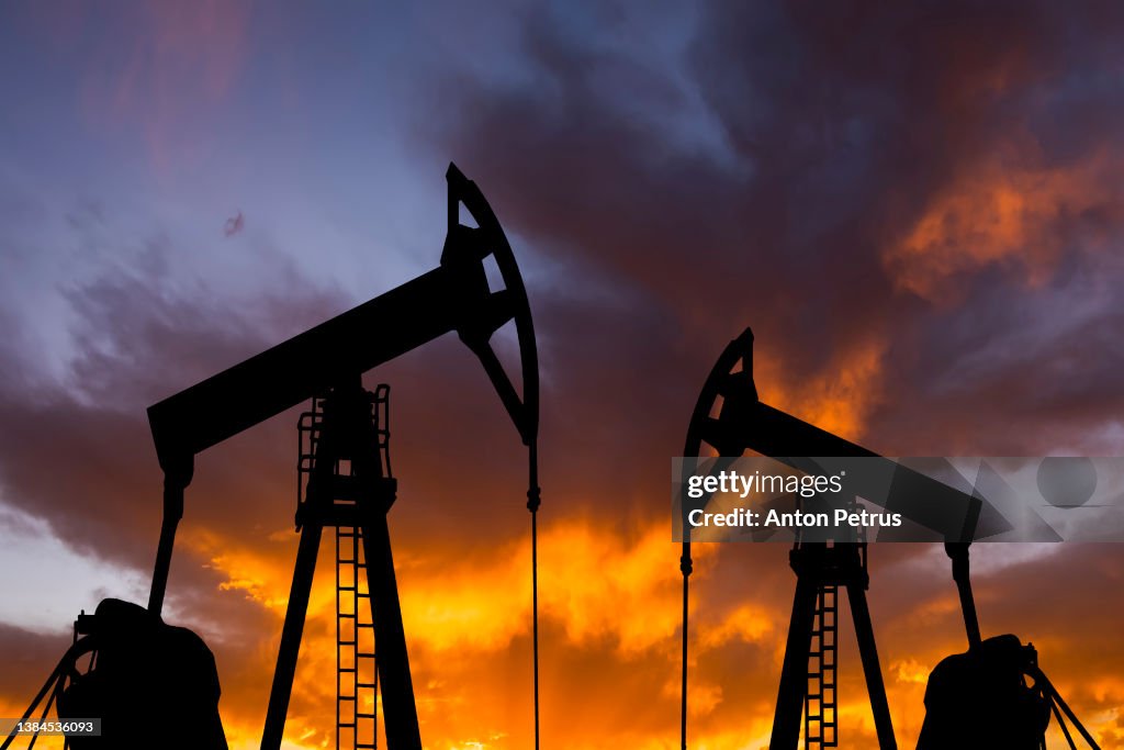 Oil pump on a sunset background. World Oil Industry