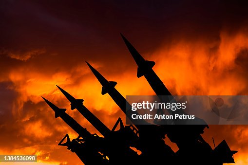 Threat of nuclear war. Missile system on the background of sunset sky Threat of nuclear war. Missile system on the background of sunset sky