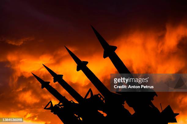threat of nuclear war.  missile system on the background of sunset sky - contaminação radioativa - fotografias e filmes do acervo
